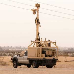 Mobile command center vehicle with surveillance equipment, designed for homeland security operations, showcasing PowerTech generator capabilities in rugged environments.
