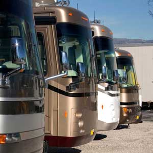 Luxury coaches lined up, showcasing sleek designs and efficient power solutions for onboard comfort and entertainment.