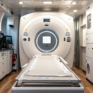 Mobile medical generator inside a mobile clinic, featuring a CT scanner with a patient bed, designed for providing reliable power to essential medical equipment in mobile healthcare services.